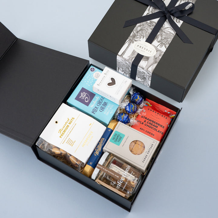 Premium men’s gift box with gourmet chocolate, cookies, brownie, and nuts packaged in a stylish  black gift box. 