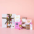 Load image into Gallery viewer, The Women’s Luxe gift box featuring gourmet treats and indulgent goodies,  presented in an elegant white gift box
